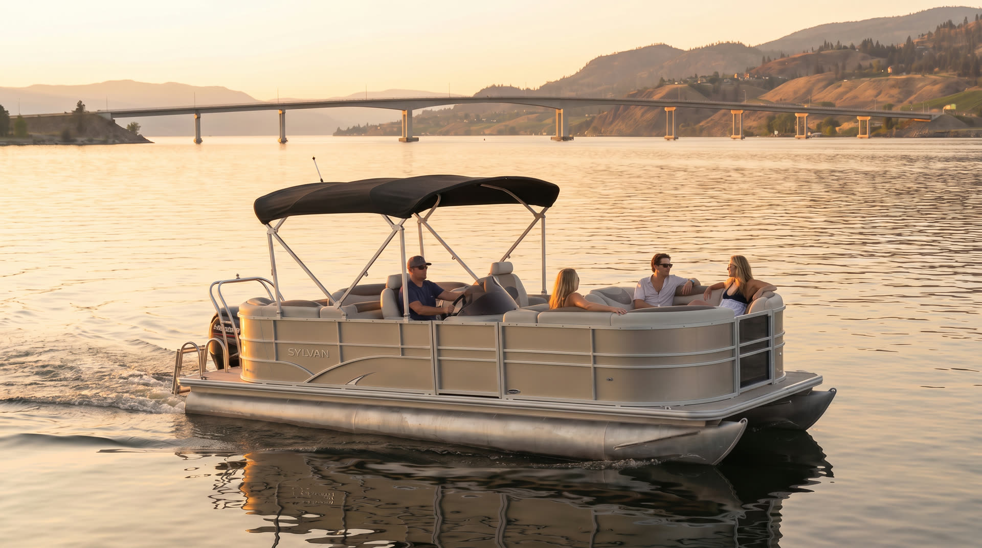 The pontoon cruising open water with the W.R. Bennett Bridge behind